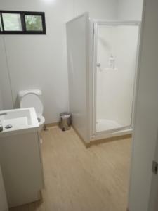 a bathroom with a shower and a toilet and a sink at Family Friendly in Howard Springs