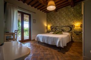 sypialnia z łóżkiem i stołem w pokoju w obiekcie Cerchio Verde w mieście Pitigliano