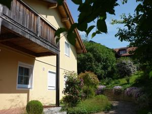 a house with a balcony and a garden at meywohnen Bad Endorf in Bad Endorf