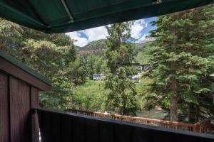 a view from the balcony of a house with trees at Manitou Lodge 9 by Alpine Lodging Telluride in Telluride