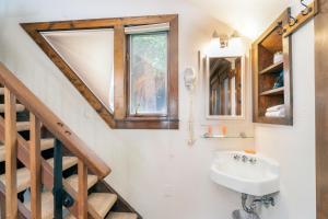 a bathroom with a sink and a staircase at Manitou Lodge 11 by Alpine Lodging Telluride in Telluride