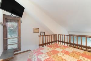 a bedroom with a bed and a large window at Manitou Lodge 11 by Alpine Lodging Telluride in Telluride
