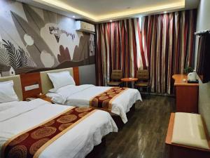 a hotel room with two beds in a room at Thank Inn Plus Hotel Henan Luoyan Yanshi Luosheng Building in Yanshi
