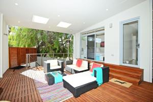 a living room with furniture and a balcony at Luxury and Beachfront on Franklin in Encounter Bay