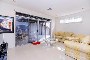 a living room with a couch and a table at Luxury and Beachfront on Franklin in Encounter Bay