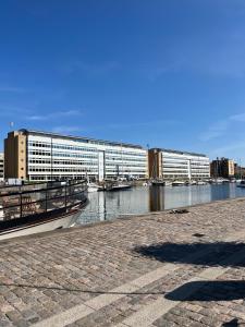 a large building next to a river with boats in it at Copenhagen centre luxury apartment - Østerbro in Copenhagen
