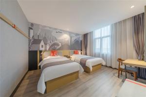 a hotel room with three beds and a desk at Thank Inn Chain Hotel Lanshan District Yitang in Linyi