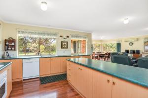 a kitchen with a large counter top and a dining room at Holiday Close to the Beach Park Swimming Centre in Hayborough