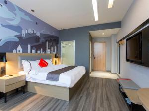 a hotel room with a large bed and a desk at Thank Inn Chain Hotel Economic and Technological Development Zone Yihe Road in Linyi