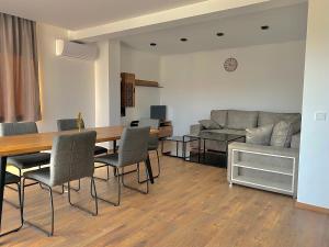 a living room with a table and chairs and a couch at Enigma Complex in Pavel Banya