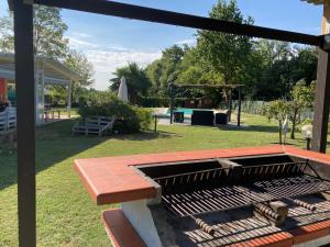 a backyard with a grill and a picnic table at CasaD in San Gillio