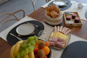 a table with a bunch of different types of food at Au Petit Canteleu - Bed & Breakfast in Beloeil