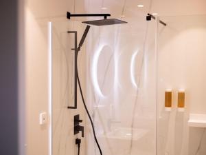 a bathroom with a shower with a glass door at Seth Port Mahón in Mahón