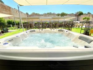 a large hot tub in the middle of a yard at Cave Bianche Hotel in Favignana