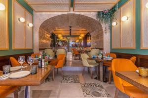 a restaurant with wooden tables and chairs and an archway at Studio room 11 with kitchenette in the heart of St Julians in Paceville