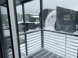 a view from a window of a snow storm at Courtyard Loft 12 The Stables Perisher in Perisher Valley