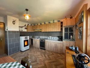 a kitchen with wooden cabinets and a stove top oven at Ferienhütte Simon Gregor in Eitweg