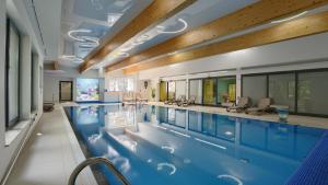 a large indoor pool with a large swimming pool at Apartamenty Sun & Snow Family Dominikana Resort & SPA in Sianozety