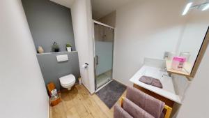 a small bathroom with a toilet and a sink at Au Petit Canteleu - Bed & Breakfast in Beloeil