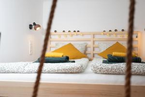 1 dormitorio con 2 camas con almohadas amarillas en Green Goblin Apartment with FREE PRIVATE PARKING en Budapest