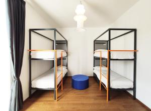 two bunk beds in a small room with a ceiling at Tric Trac Hostel in Naples