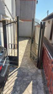 an open gate to a house with a driveway at Ana apartman in Bar