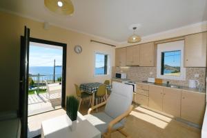 a kitchen with a view of a balcony at Captains View Apartments in Platy