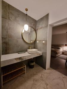 a bathroom with a sink and a mirror on the wall at Seaside Murter Apartments in Murter +41 photos