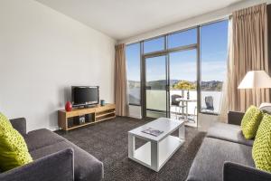 a living room filled with furniture and a tv at Quest Albury in Albury