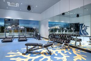 a gym with dumbbells and weights on a carpet at Ocean Marina Resort Pattaya Jomtien in Na Jomtien