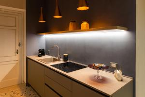 a kitchen with a sink and a bowl of food on a counter at Casa Franca in Marsala