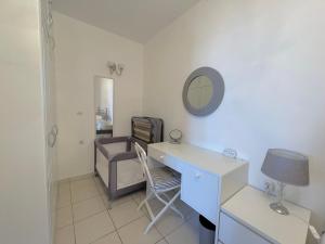 a room with a desk and a chair and a mirror at Bluview, Glyfada, Corfu in Glyfada