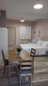 a living room with a table and a bed at Deluxe Summer Studio Tolo in Tolo