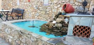 a small swimming pool in a stone wall at Margherita's holidays home in Agios Spiridon Fokidas