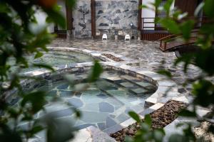 ein Pool mit Stühlen mitten im Garten in der Unterkunft Onsen at Moncham in Chiang Mai