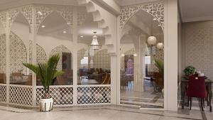 a dining room with a table and a potted plant at Reikartz Sote Tashkent in Tashkent
