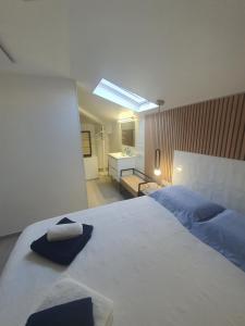 a bedroom with a large bed and a bathroom at Villa Daniel Saint Aygulf in Fréjus