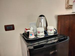 un vassoio con tazze di caffè sopra un fornello di La Casa di Lisa a San Vincenzo