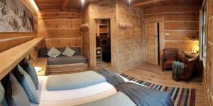 a bedroom in a log cabin with a bed at Drevenica Luki in Ždiar