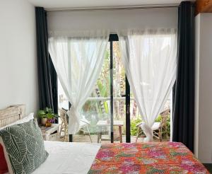 a bedroom with a bed and a large window at One Thousand Waves in Moraira