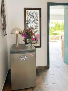 a refrigerator with a vase of flowers on top of it at One Thousand Waves in Moraira