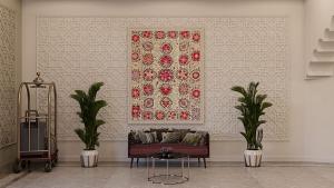 a living room with a couch and a picture on the wall at Reikartz Sote Tashkent in Tashkent