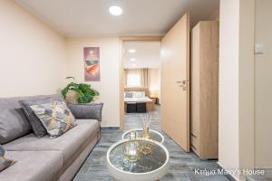 a living room with a couch and a table at Κτήμα Mairy΄s House in Flogita