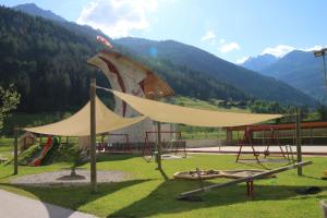 a playground in front of a building with a tent at Ferienhaus Goldene Zehn 