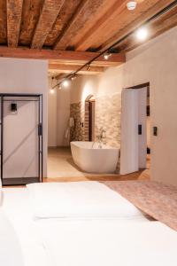 a large bathroom with a tub and a sink at H5 Grauer Bär Studios & More in Innsbruck