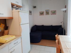 a living room with a couch and a kitchen at Apartment Tereza in Sutivan