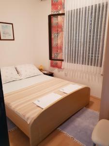 a bed sitting in a room with a window at Apartment Tereza in Sutivan