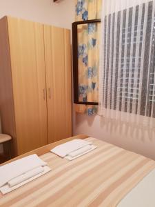 a bedroom with a bed with two towels on it at Apartment Tereza in Sutivan