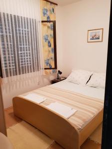 a large bed in a bedroom with a window at Apartment Tereza in Sutivan