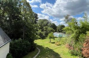 a train traveling through a field with trees at La Fantasia in Saint-Sylvain-dʼAnjou